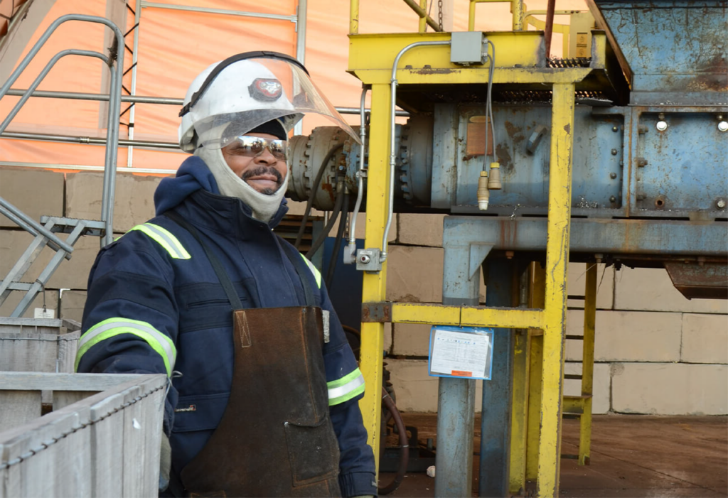 Manufacturing employee wearing safety gear in an industrial facility